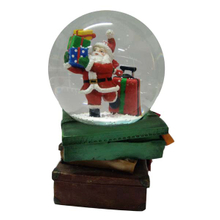 Santa Claus with gift snow globe